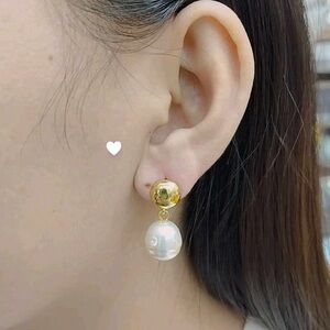 gold-plated pearl earrings with a unique and modern design.